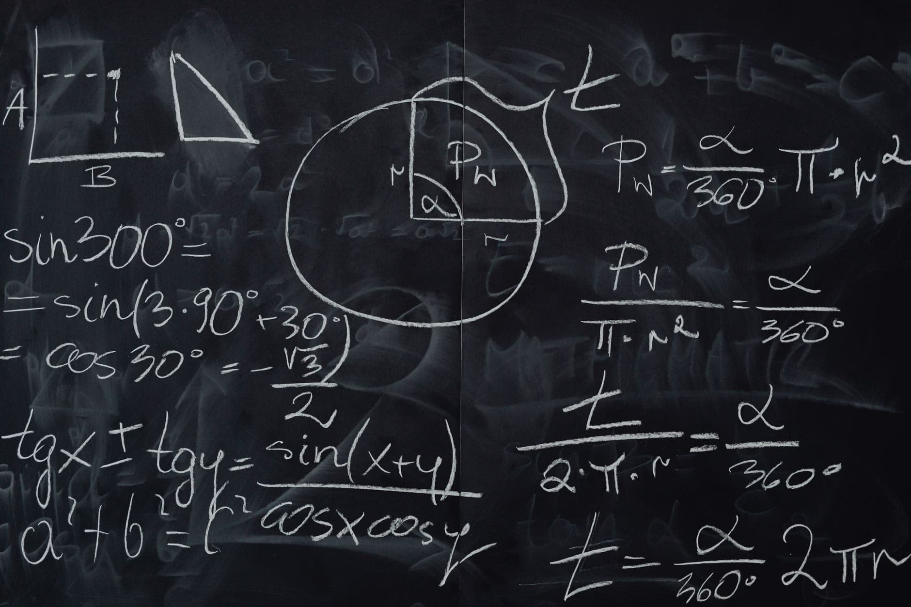 Trigonometry equations and diagrams written on a blackboard