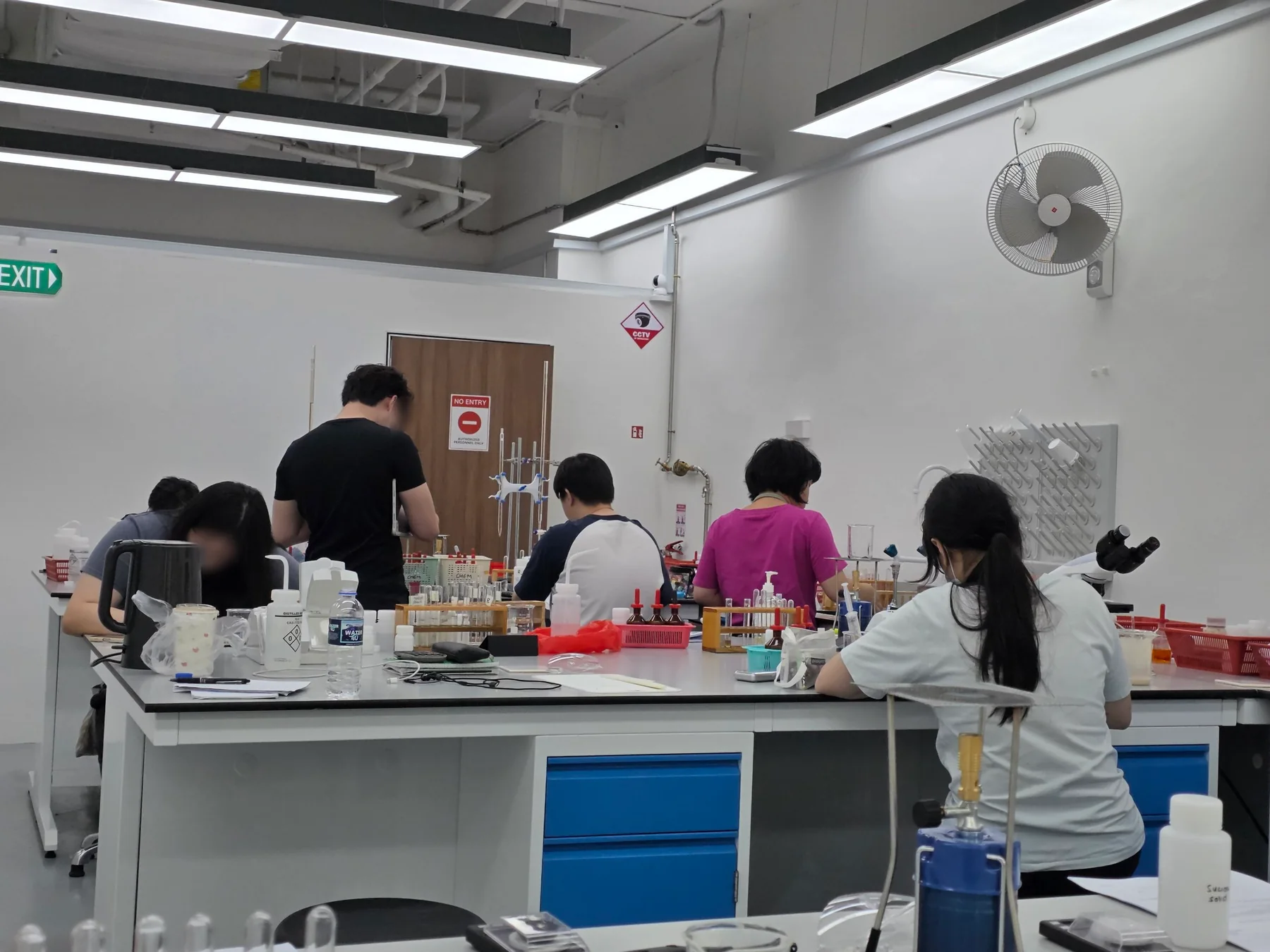 Students working at shared benches in Eclat's Henderson Road laboratory