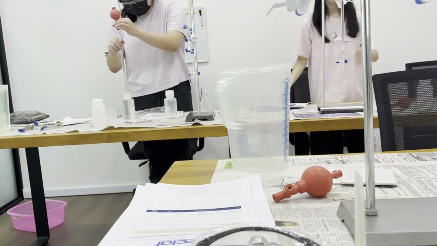 Students handling pipettes and volumetric apparatus during an Eclat Chemistry practical