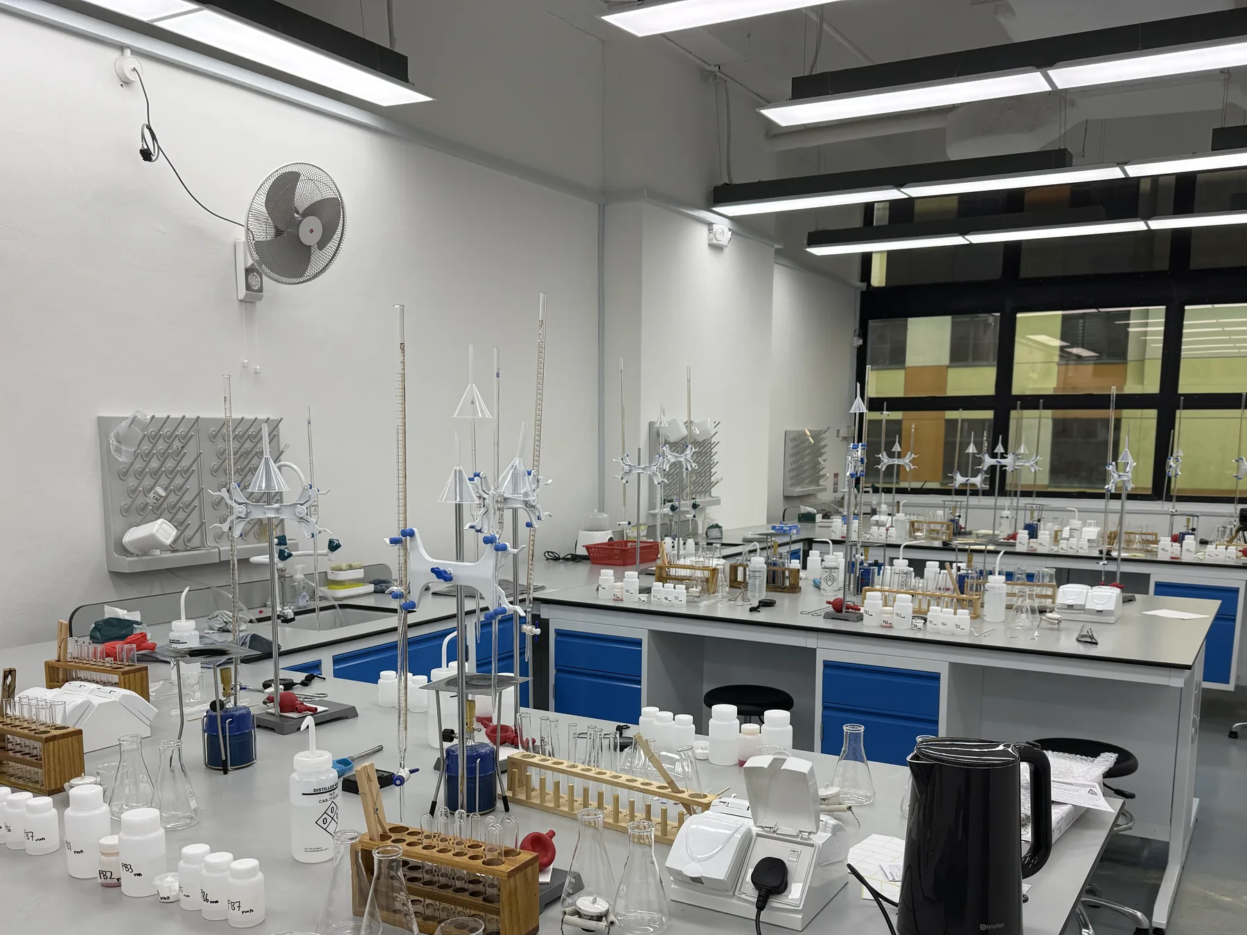 Chemistry benches set out with burettes, retort stands and reagent bottles at our Henderson lab.